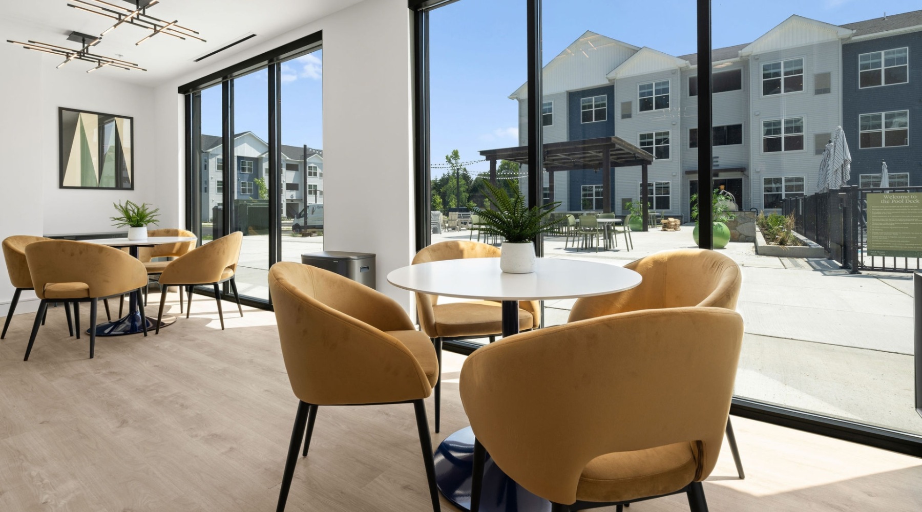a naturally lit room with tables and chairs