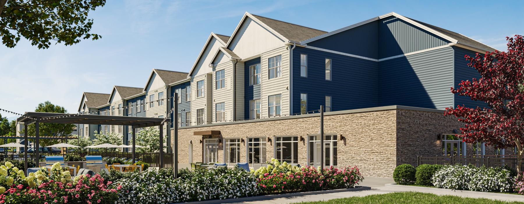a large building with a lawn and trees in front of it