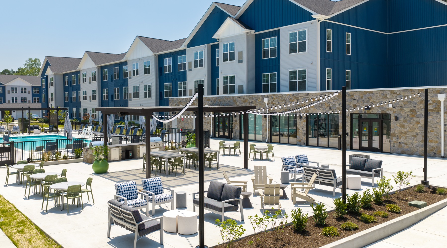 an outdoor area with tables, chairs and landscaping