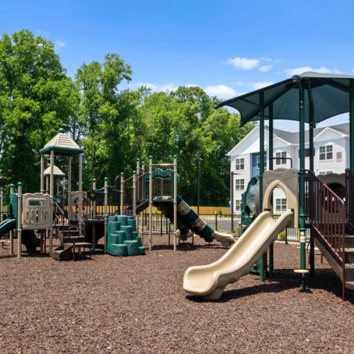 a tot lot with swings and a slide