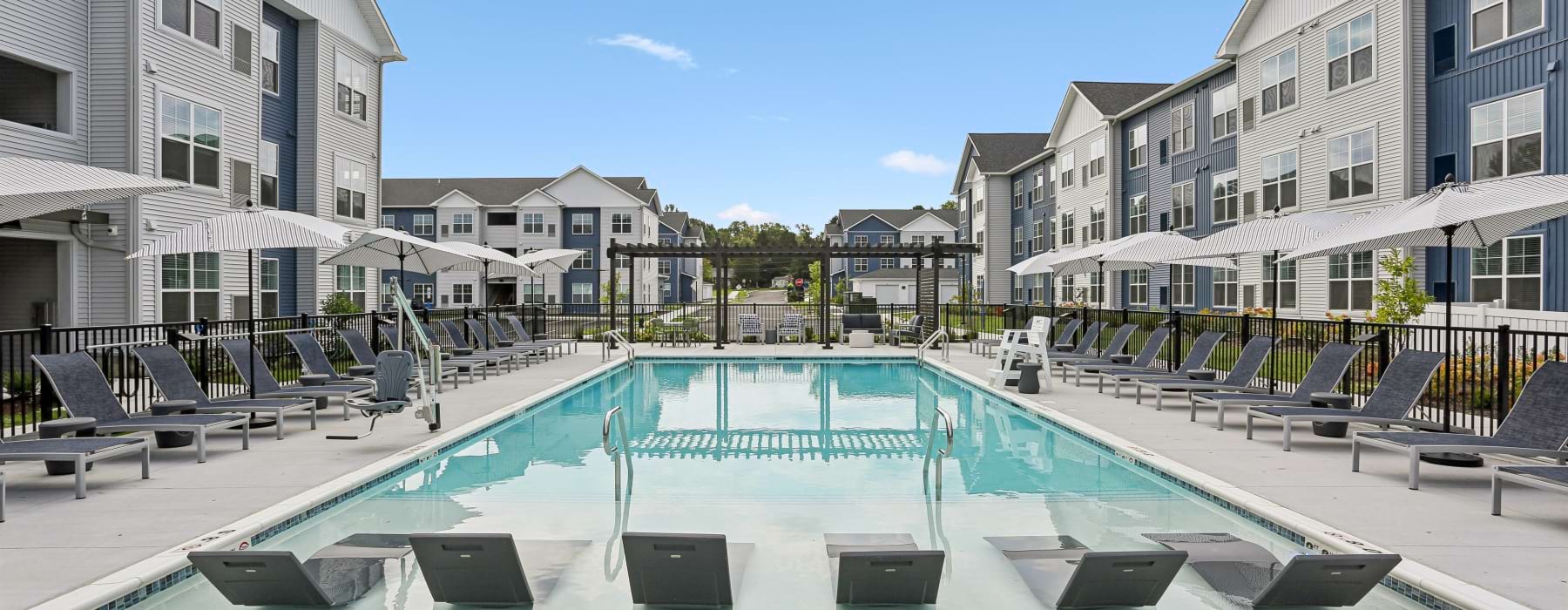 Pool with lounge seating and umbrellas