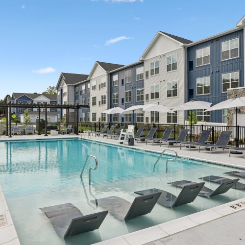 Resort-style swimming pool with lounge seating