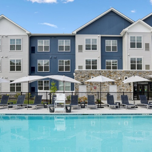 Resort-style swimming pool with lounge seating