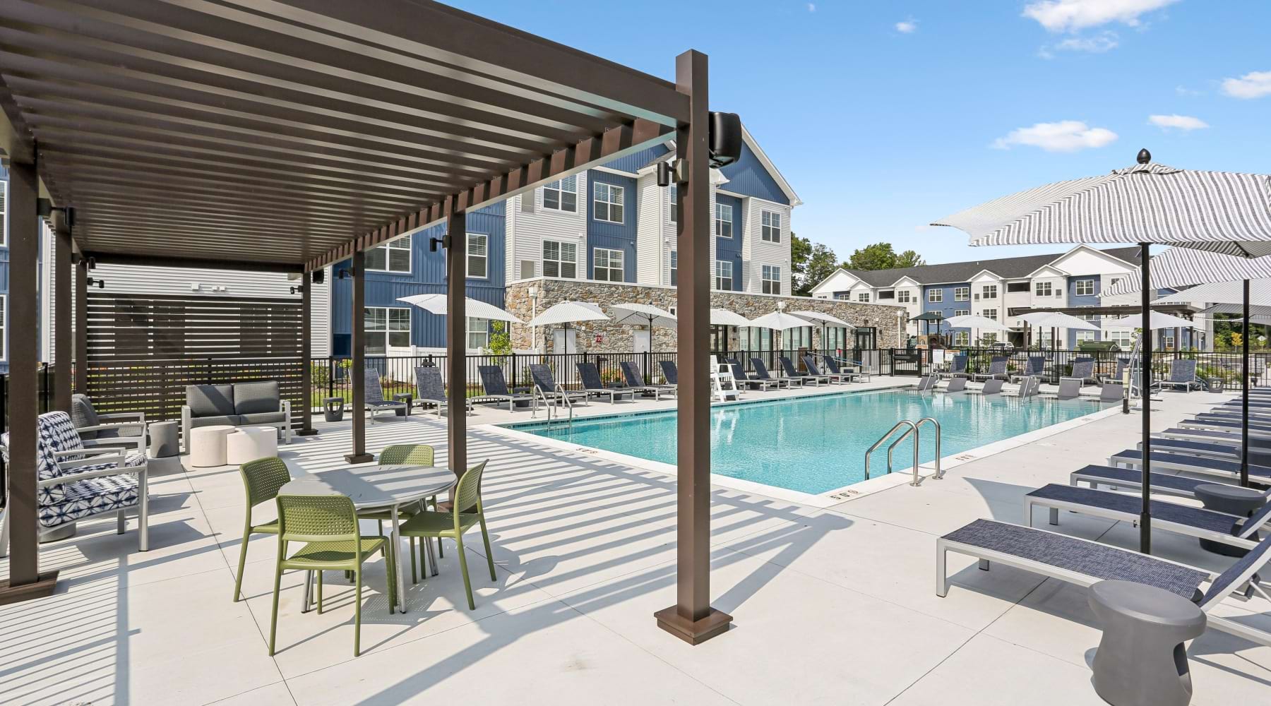 Outdoor lounge with tables and chairs at The Randall apartments in Woodbury Heights.	